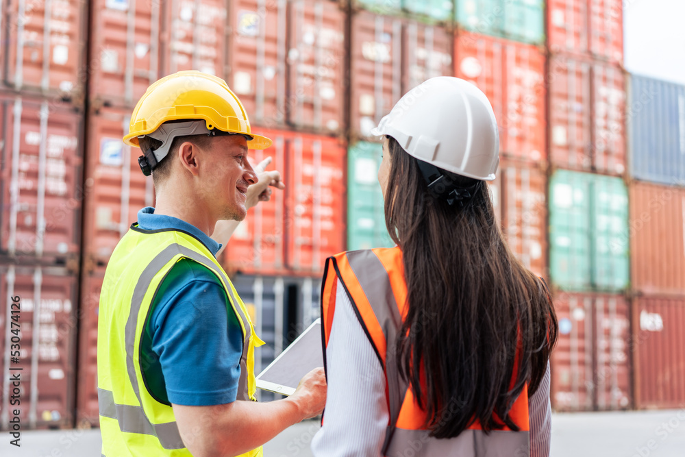 Caucasian business man and woman worker working in container terminal. Caucasian business man and woman worker working in container terminal.