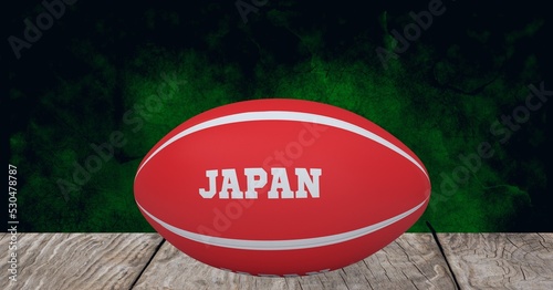 Composition of rugby ball decorated with text japan on black background