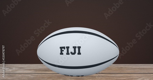 Composition of rugby ball decorated with text fiji on black background