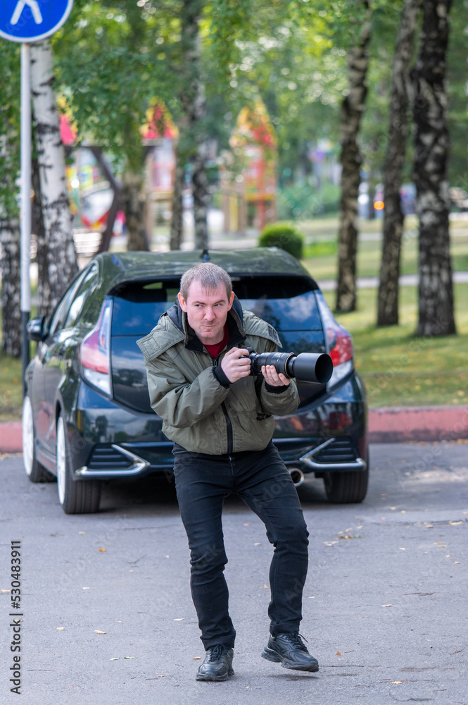 Cheerful street photographer on the city street Cheerful street photographer on the city street