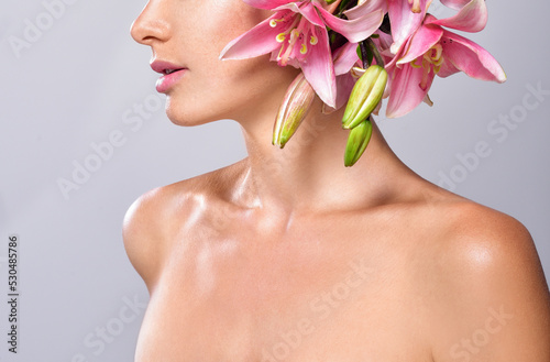 Beautiful woman with flowers in her hair. Bouquet of Beautiful Flowers. Hairstyle with flowers. Nature Hairstyle.