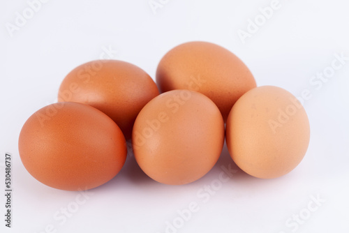 five eggs are placed on a white background with free space on right