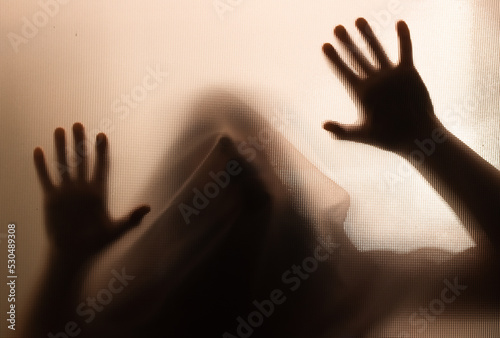 Fotografie Shadowy figure behind glass - horror background