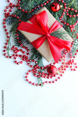 christmas greeting card mockup. fir branches with Christmas decorations and an envelope with a white blank for text	