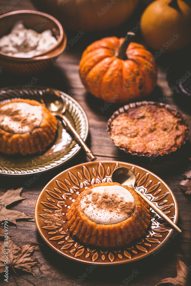 Pumpkin mini pie, tartlet made for Thanksgiving day on old wooden background Pumpkin mini pie, tartlet made for Thanksgiving day on old wooden background