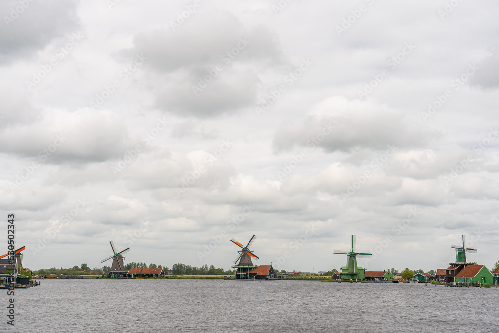 Rural landscape with windmill in Zaanse Schans. Holland, Netherlands. Authentic Zaandam mill. Beautiful Netherland landscape.