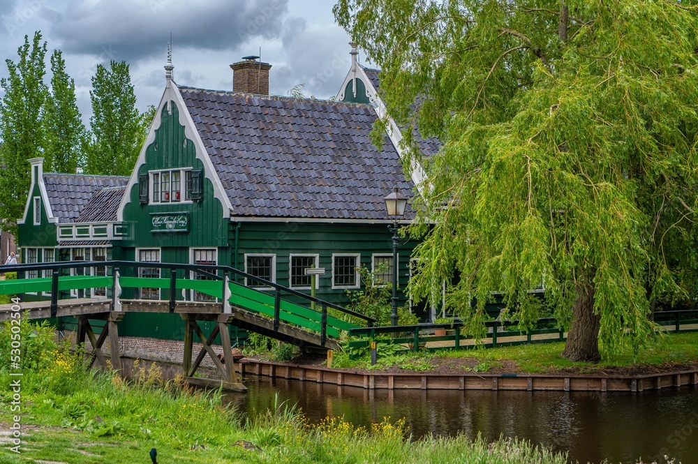 Rural landscape with windmill in Zaanse Schans. Holland, Netherlands. Authentic Zaandam mill. Beautiful Netherland landscape. Rural landscape with windmill in Zaanse Schans. Holland, Netherlands. Authentic Zaandam mill. Beautiful Netherland landscape.