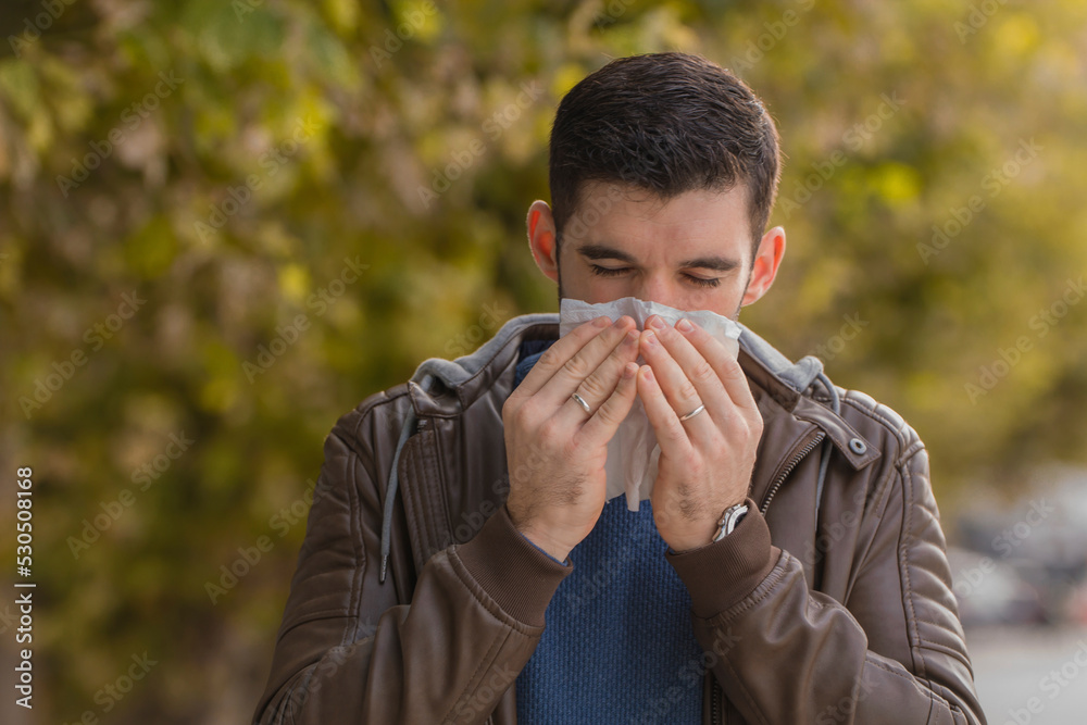 Man with allergy or an infection sneezing Man with allergy or an infection sneezing