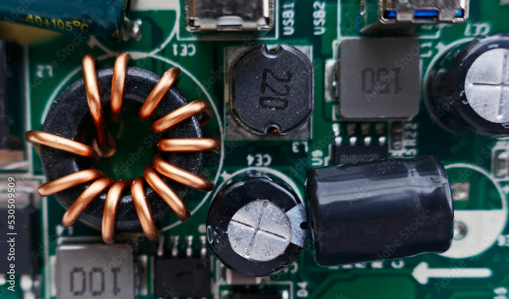 Macro photo of an electronic circuit board of a portable charger. At ...