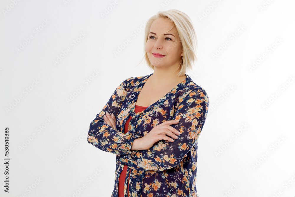 Happy beautiful close up portrait middle age blonde woman. Mid aged healthy female isolated on white background with copy space. Menopause and healthcare. Mature lady wrinkled face. Folded hands