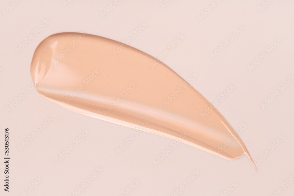 cosmetic smear foundation cream foundation on a beige background