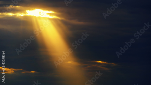 bright sun ray through dark dramatic sky with storm clouds, extreme weather sky for abstract background