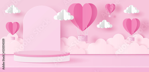 Paper cut of Valentine's Day background with pink cylinder podium, heart hot air balloons and clouds for products display presentation.
