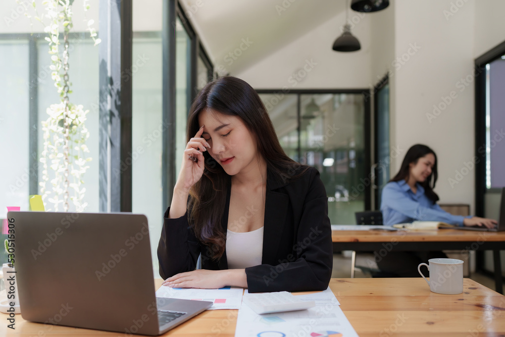 Stressed Asian business woman worry with many document on desk at office Stressed Asian business woman worry with many document on desk at office