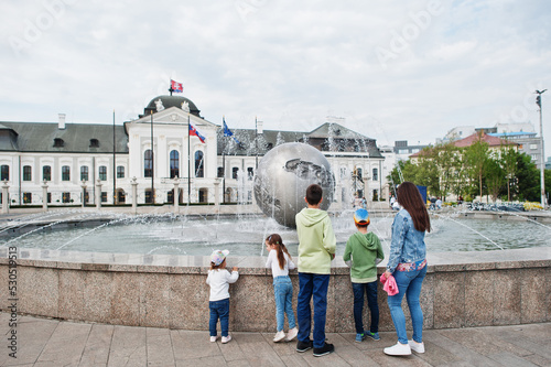 Mother with kids walking at Grassalkovich Palace, Bratislava, Europe. Residence of the president of Slovakia in Bratislava.