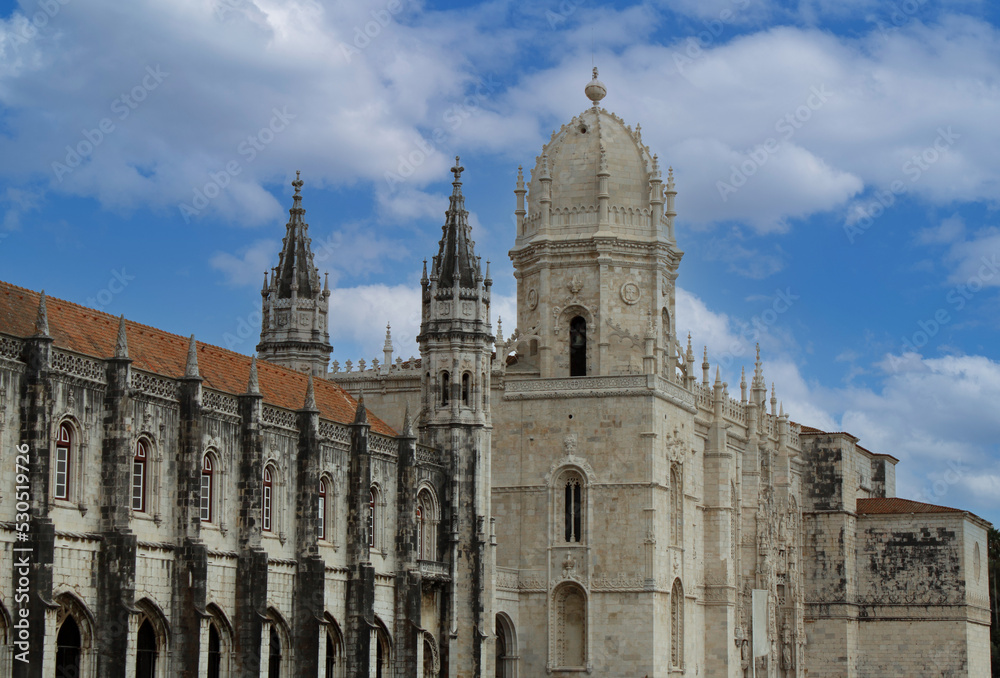 Ancient walls and towers of the Jeronimos Monastery (Mosteiro dos Jerónimos) in Lisbon, Portugal, Europe. Portuguese Gothic Manueline style of architecture. Exterior of the main church and cloister.