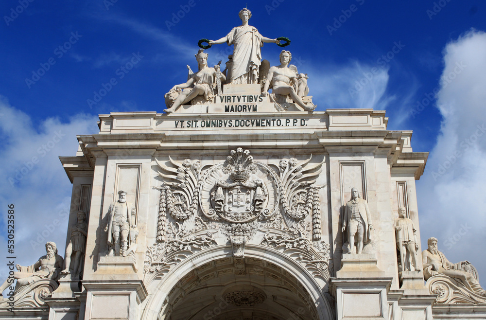 Monument and statues at Lisbon Main Square; Lisbon, Portugal, Europe. This historical Triumphal Arch is the gate that connects Lisbon to the Tagus river. Commerce Square view with Rua Agusta.