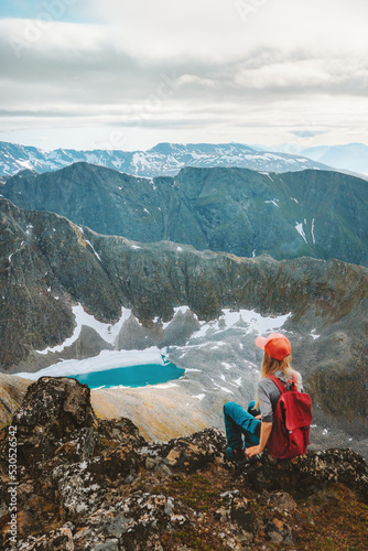 Backpacker woman enjoying view of  mountain lake in Norway hiking outdoor Travel adventure healthy lifestyle trip active vacations eco tourism photo