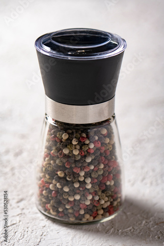 glass pepper mill on white background