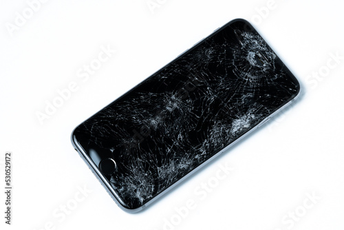 smartphone with broken screen isolated on white background
