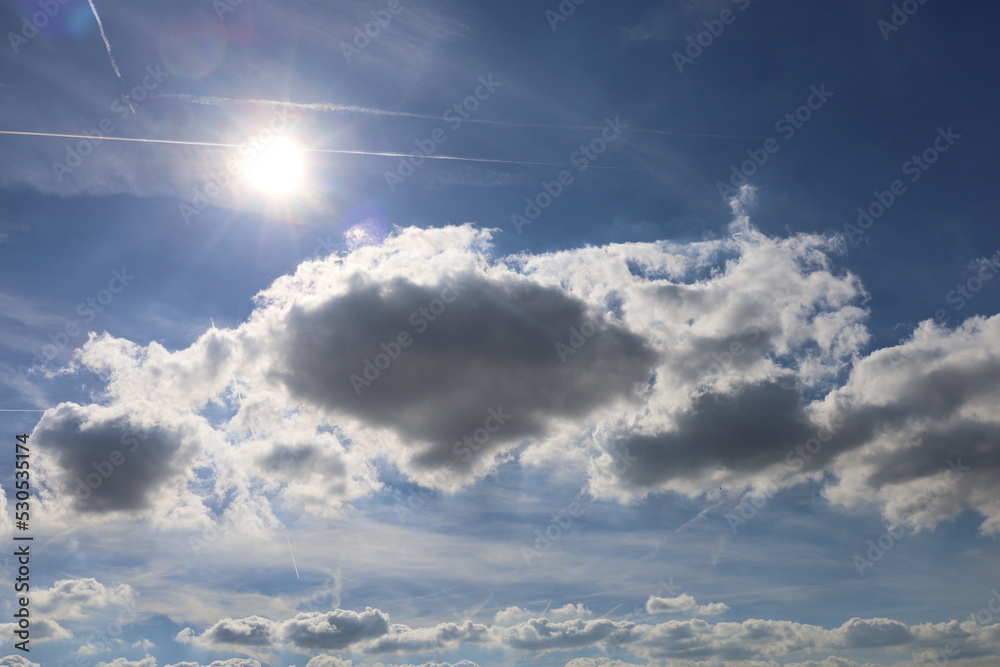 blue sky background with clouds and sun Stock Photo | Adobe Stock