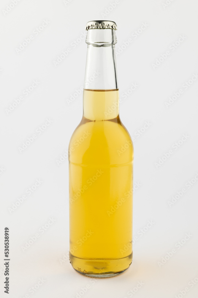Image of clear glass full lager beer bottle with crown cap, with copy space on white background Image of clear glass full lager beer bottle with crown cap, with copy space on white background