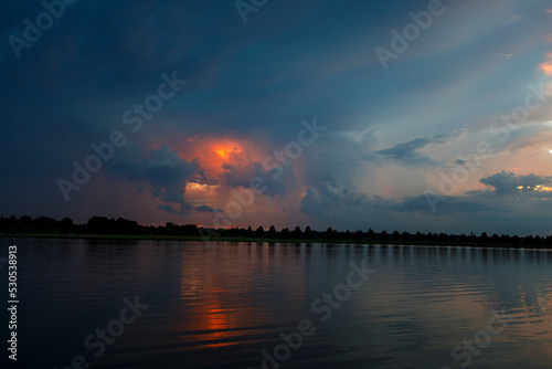 Dramatic sunset and reflections on the water on Patriot Lake in Shelby Farms Park, Memphis, TN. © DWBMedias