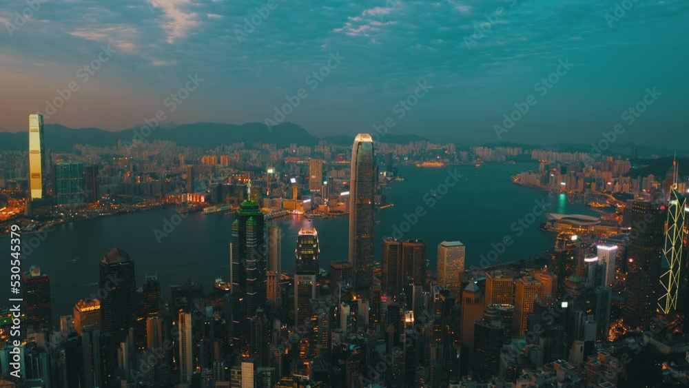 Drone shot traveling to the left of the bay of Hong Kong nearly at night showing the extent of the wealth of the city and the boat traffic. Drone shot traveling to the left of the bay of Hong Kong nearly at night showing the extent of the wealth of the city and the boat traffic.