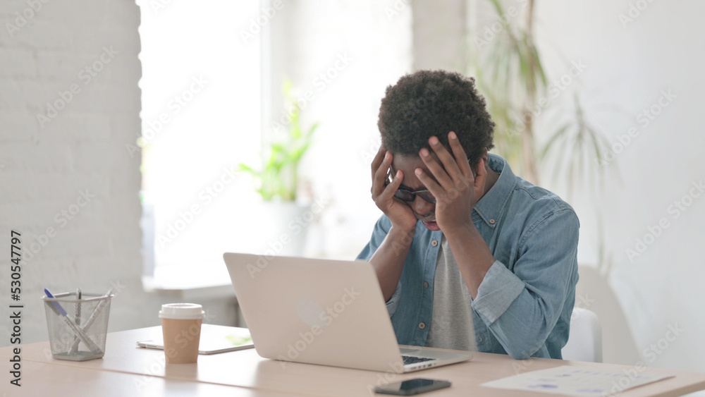 Young African Man Reacting to Loss While using Laptop