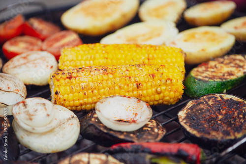 corn with paprika spice and vegetables is cooked on the grill