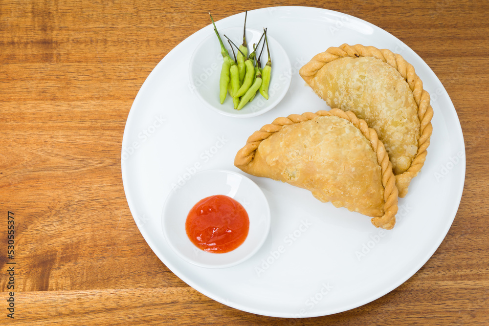 Kue Pastel or fried patties or empanadas, a popular snack in Indonesia with the skin filled with various fillings such as vermicelli, vegetables, chicken. With a wavy edge of dough on the side