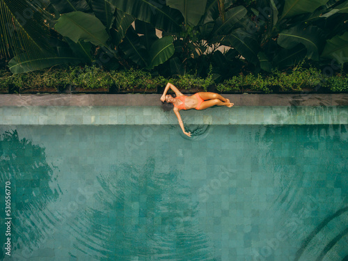 Beautiful woman lying at the poolside © Jacob Lund