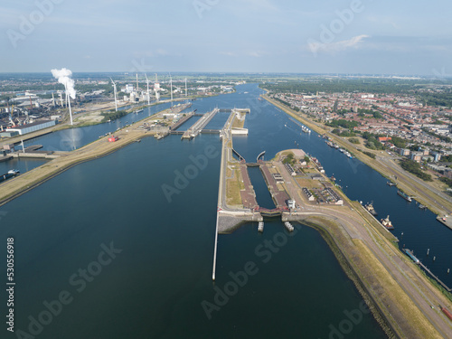 The IJmuiden locks form the connection between the North Sea Canal and the North Sea at IJmuiden . Zeesluis Ijmuiden sea lock infrastructure connecting the river with the sea.