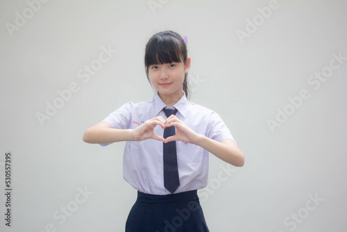 Portrait of thai high school student uniform beautiful girl give heart