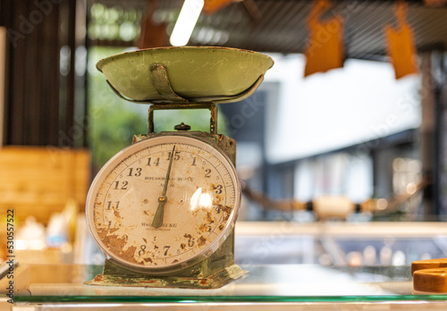 old scales on a glass table in the market