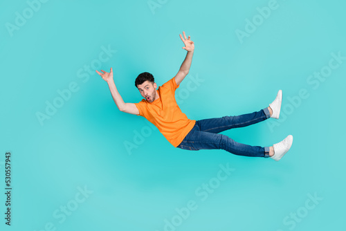 Full size photo of guy falling down feel stupor isolated on aquamarine color background