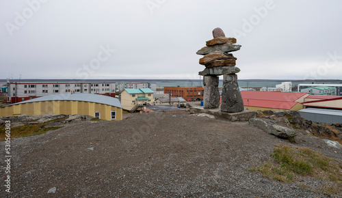 Inukshuk (Inuksuk) on hilltop above the town Rankin Inlet on the Hudson Bay photo
