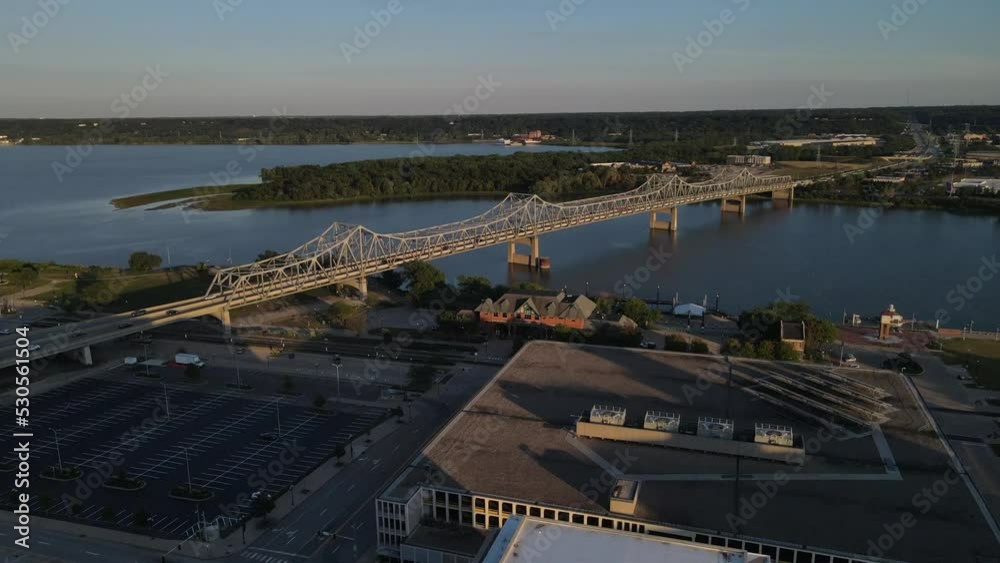High aerial view of the traffic crossing the Murray Baker bridge in Peoria, Illinois at sunset.  The sun highlights the structural nature of the bridge