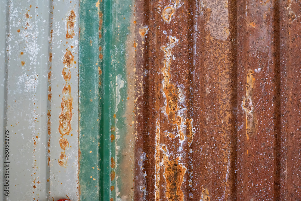 The background of the zinc folds is rusty, has roughness and decay.