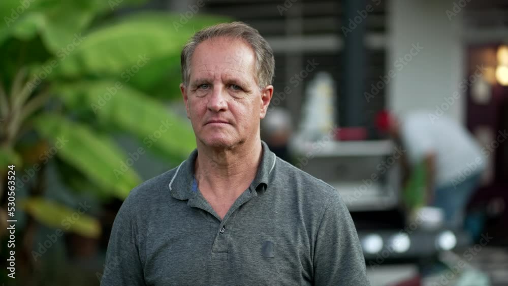Portrait of an older man with serious expression standing outdoors looking at camera. closeup senior male face Portrait of an older man with serious expression standing outdoors looking at camera. closeup senior male face