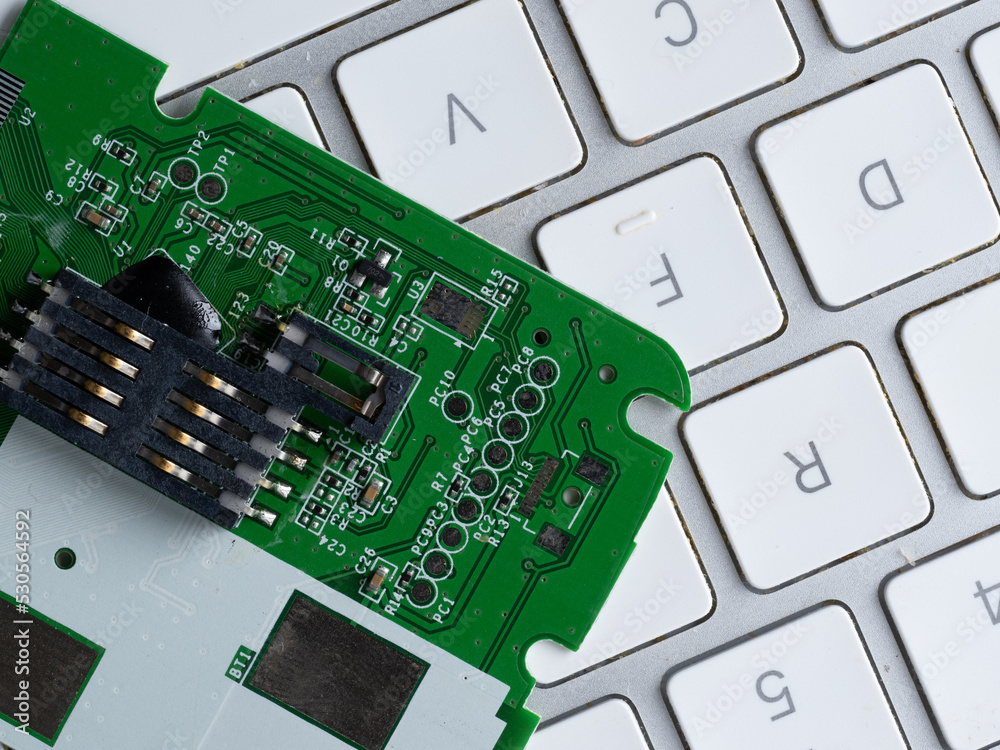 printed circuit board with resistors capacitors on a computer keyboard printed circuit board with resistors capacitors on a computer keyboard