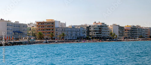 Buildings on the coastline of Loutraki, Greece. Sunny summer day. panoramic view photo