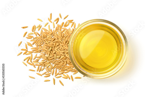 Top view of Rice bran oil with paddy rice isolated on white background. photo