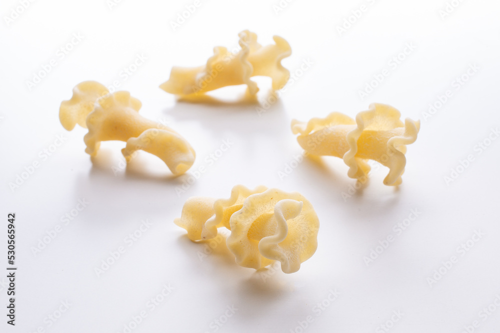 small composition of durum wheat pasta on a white background small composition of durum wheat pasta on a white background