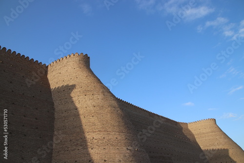 Ancient defence wall islamic architecture yellow sand stone uzbekistan in sunny weather