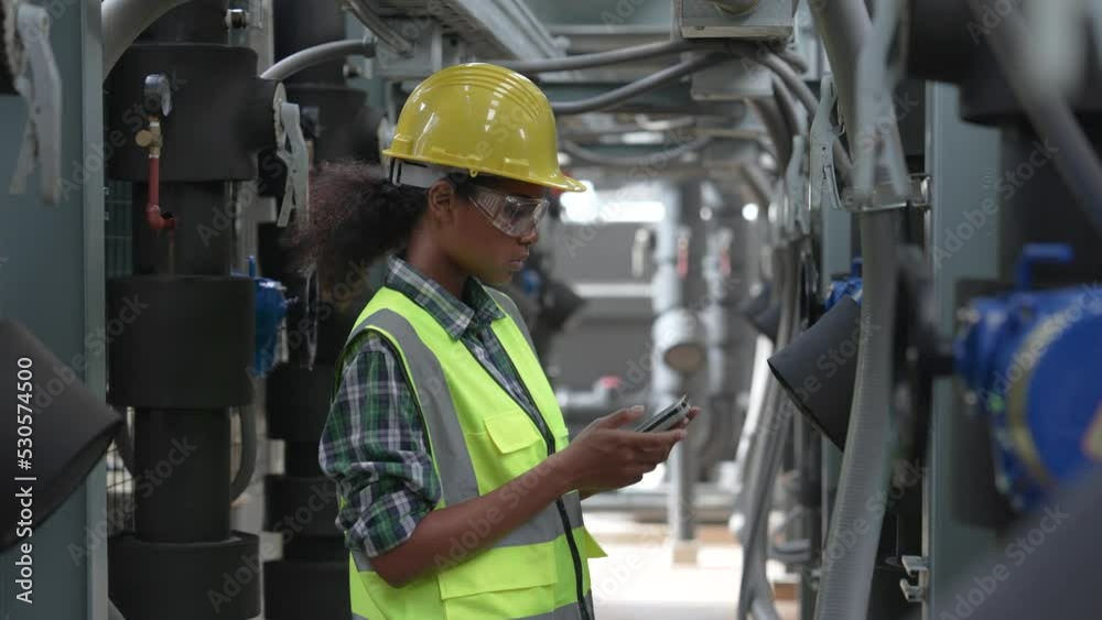 Engineer checking the cooling system of the factory air conditioner. Engineer checking the cooling system of the factory air conditioner.