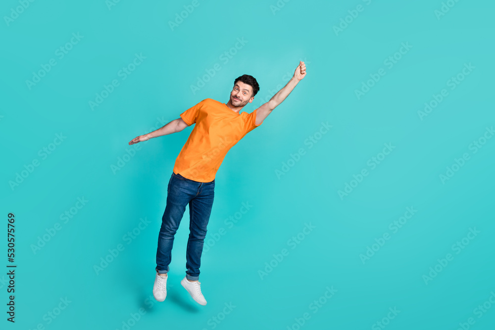 Full length body size view of sporty active energetic man jumping hanging empty blank space isolated on cyan color background