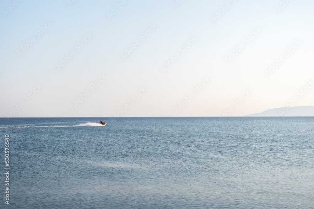 Sea Motor from a distance in calm sea. Selective Focus Vehicle