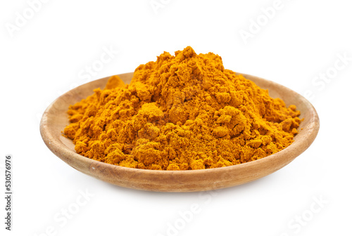 a pile of ground turmeric powder or curcumin powder in wood plate isolated on white background. turmeric or curcumin powder isolated 