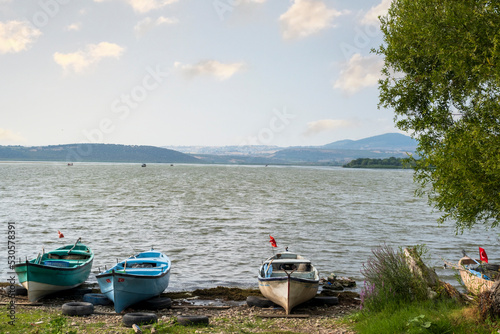 Fishing boats on the shore of Lake Apolyont. Uluabat, Gölyazı, Bursa, Turkey. Selective Focus Boat.